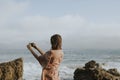 Woman taking photos with her phone on the beach Royalty Free Stock Photo