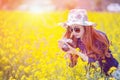 Woman taking photos at a rapeseed flowers.