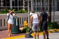 Woman taking photos of spring break tourists in Miami Beach