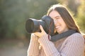 Woman taking photos in winter with pro camera Royalty Free Stock Photo