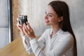 Young woman taking picture at cafe. Creative hobby Royalty Free Stock Photo