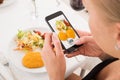 Woman Taking Picture Of Food With Mobile Phone Royalty Free Stock Photo