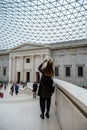 Woman taking picture in the Great Court, British Museum, London Royalty Free Stock Photo