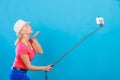 Woman taking picture of herself with phone on stick Royalty Free Stock Photo