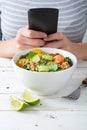 Woman taking a picture to food with a mobile phone Royalty Free Stock Photo