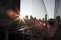 Woman taking a picture to Manhattan views at Brooklyn Bridge. Ra