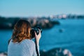 woman taking pictures on camera sea in mountains back view Royalty Free Stock Photo