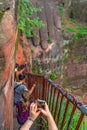 Woman taking pictures of Giant Leshan Buddha