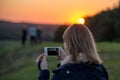 Woman taking pictures with her phone camera Royalty Free Stock Photo