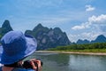 Woman taking pictures of Li River in China Royalty Free Stock Photo