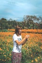 Woman taking pictures of marigold field. Bali island. Royalty Free Stock Photo