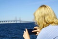 Woman taking pictures at Oresund Bridge Royalty Free Stock Photo