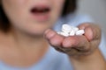 Woman taking pills, girl with open mouth holding white tablets in palm of hand Royalty Free Stock Photo