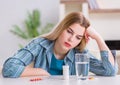 Woman taking pills to cope with pain Royalty Free Stock Photo