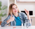 Woman taking pills to cope with pain Royalty Free Stock Photo