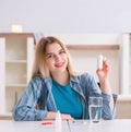 Woman taking pills to cope with pain Royalty Free Stock Photo