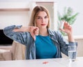 Woman taking pills to cope with pain Royalty Free Stock Photo