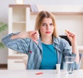 Woman taking pills to cope with pain Royalty Free Stock Photo