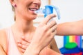 Woman taking pulmonary function test with mouthpiece in her hand