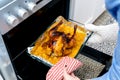 Woman taking roast chicken oven tasty food Royalty Free Stock Photo