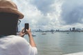 Woman taking sea photo with her smart phone. Royalty Free Stock Photo