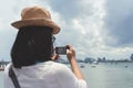 Woman taking sea photo with her smart phone. Royalty Free Stock Photo