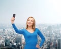 Woman taking self picture with smartphone camera Royalty Free Stock Photo
