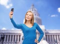 Woman taking self picture with smartphone camera Royalty Free Stock Photo