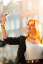 Woman taking self picture with smartphone camera Royalty Free Stock Photo