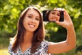 Woman Taking Self Portrait with Phone Camera