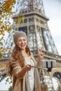 Woman taking selfie with cellphone and showing victory in Paris Royalty Free Stock Photo