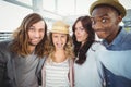 Woman taking selfie with coworkers making faces Royalty Free Stock Photo