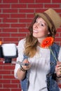 Woman taking selfie in front of brick wall Royalty Free Stock Photo