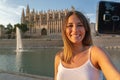 Woman taking selfie in front of cathedral