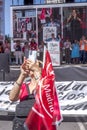 Woman taking a selfie in front of the stage during the 1st May demonstration in Madrid, Spain