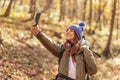 Woman taking a selfie while hiking in the forest Royalty Free Stock Photo