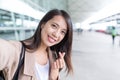 Woman taking selfie with korean style heart finger gesture