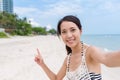 Woman taking selfie by mobile phone in beach Royalty Free Stock Photo