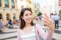 Woman taking selfie by mobile phone in Macao Royalty Free Stock Photo