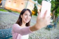 Woman taking selfie by mobile phone in Macau Royalty Free Stock Photo