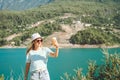 Woman taking selfie on mobile phone of mountains lake background. Traveler female having video chat on cellphone on the Royalty Free Stock Photo