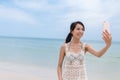 Woman taking selfie by mobile phone with the sea Royalty Free Stock Photo