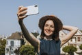 Woman taking a selfie with the Painted Ladies of San Francisco, USA