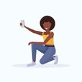 Woman taking selfie photo on smartphone camera african american female cartoon character sitting and posing on white Royalty Free Stock Photo