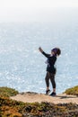 Woman taking selfie on rock with ocean in background. Bodega Bay Northern California Royalty Free Stock Photo