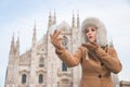 Woman taking selfie with smartphone while standing near Duomo Royalty Free Stock Photo