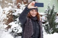 woman taking a selfie in snow Royalty Free Stock Photo