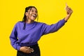 Woman Taking Selfie on Yellow Background