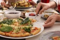 Woman taking slice of pizza during brunch at table, closeup Royalty Free Stock Photo