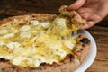 Woman taking slice of tasty cheese pizza at table, closeup Royalty Free Stock Photo